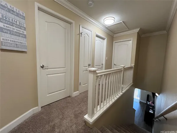 a large bed sitting in a bedroom next to a window
