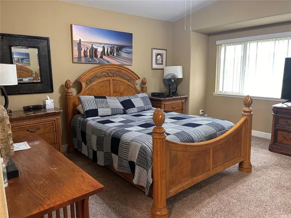 a bedroom with a bed and dresser