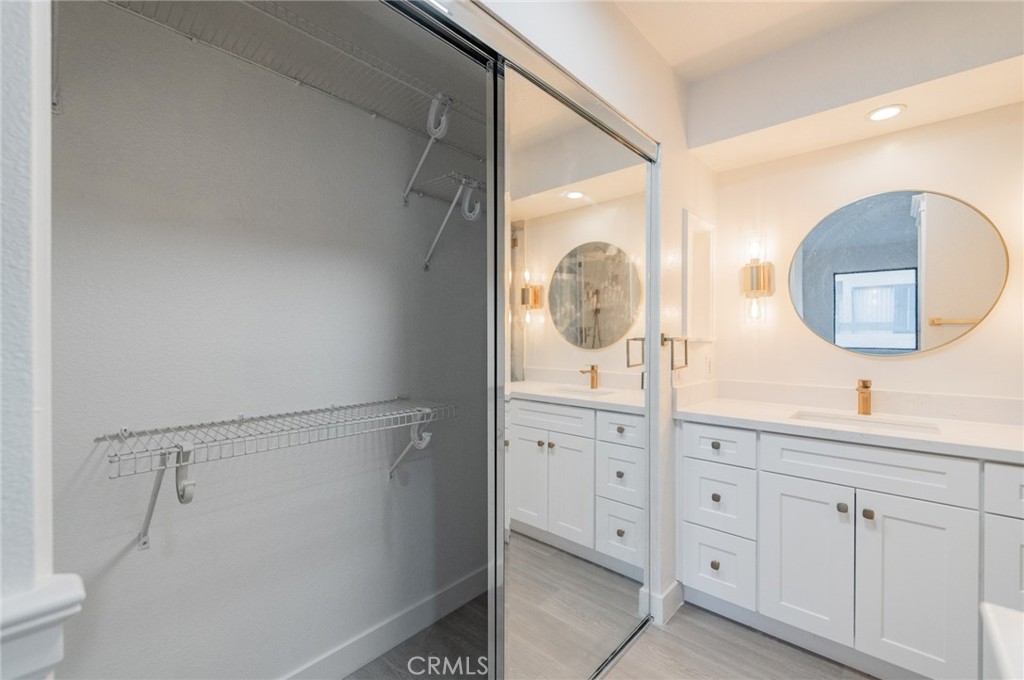 20 Rock Cliff Place Phillips Ranch, CA 91766 - Photo 14 of 17 a bathroom with a double vanity sink and a mirror