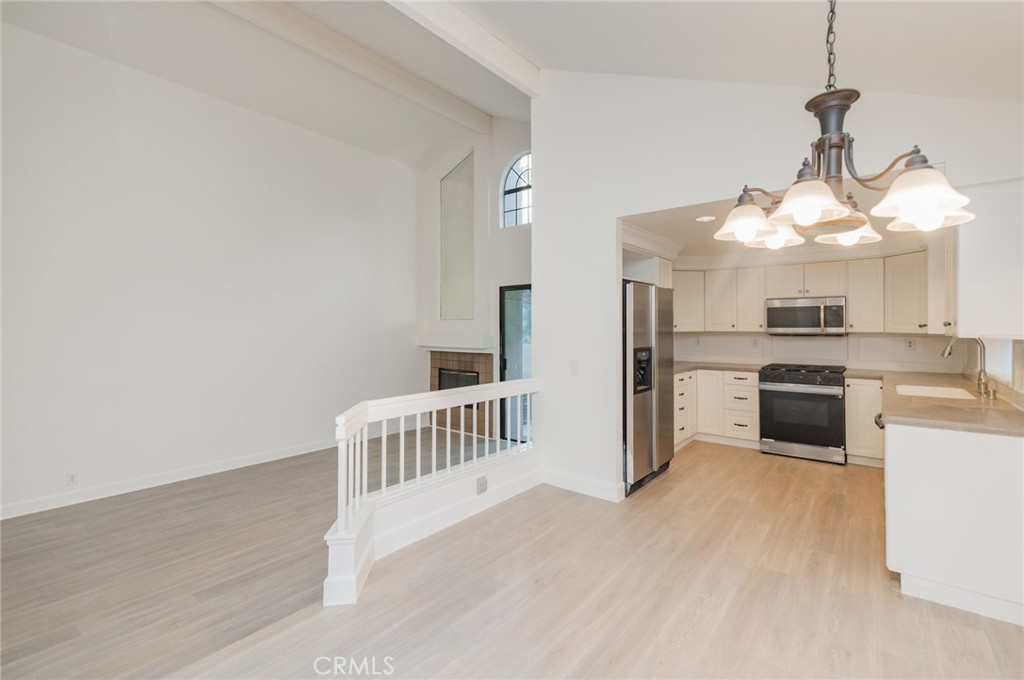 20 Rock Cliff Place Phillips Ranch, CA 91766 - Photo 4 of 17 a open kitchen with white cabinets and stainless steel appliances