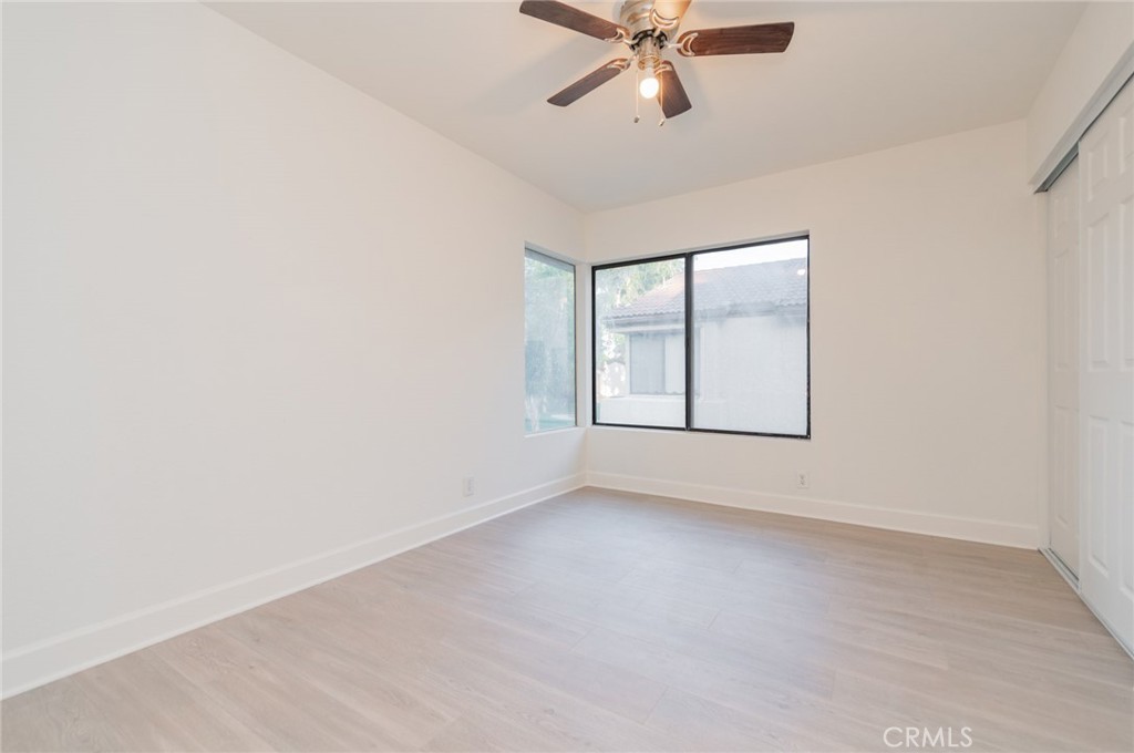 20 Rock Cliff Place Phillips Ranch, CA 91766 - Photo 8 of 17 an empty room with windows and fan