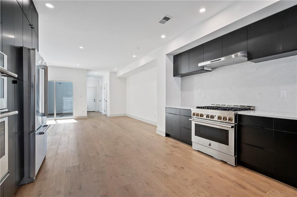 226 38th Street Pittsburgh, PA 15201 - Photo 11 of 42 a kitchen with stainless steel appliances granite countertop a stove and a refrigerator