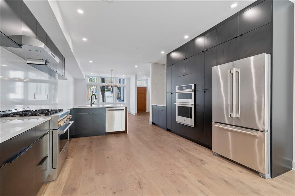 226 38th Street Pittsburgh, PA 15201 - Photo 12 of 42 a kitchen with stainless steel appliances granite countertop a refrigerator a stove and a sink