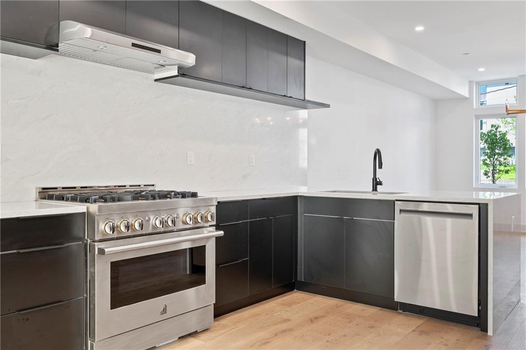 226 38th Street Pittsburgh, PA 15201 - Photo 13 of 42 a kitchen with cabinets and steel stainless steel appliances