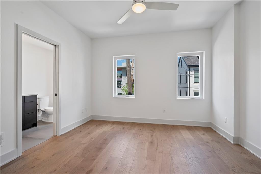 226 38th Street Pittsburgh, PA 15201 - Photo 27 of 42 an empty room with wooden floor and windows