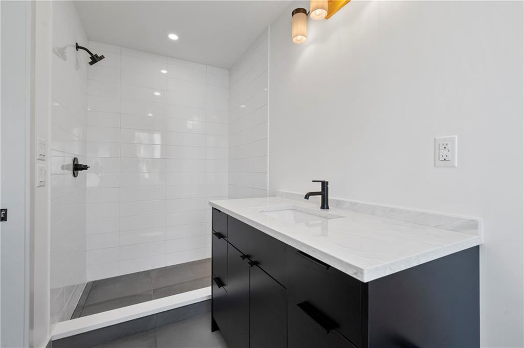 226 38th Street Pittsburgh, PA 15201 - Photo 29 of 42 a bathroom with a sink and a mirror