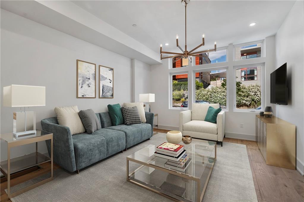 226 38th Street Pittsburgh, PA 15201 - Photo 5 of 42 a living room with furniture a flat screen tv and a chandelier