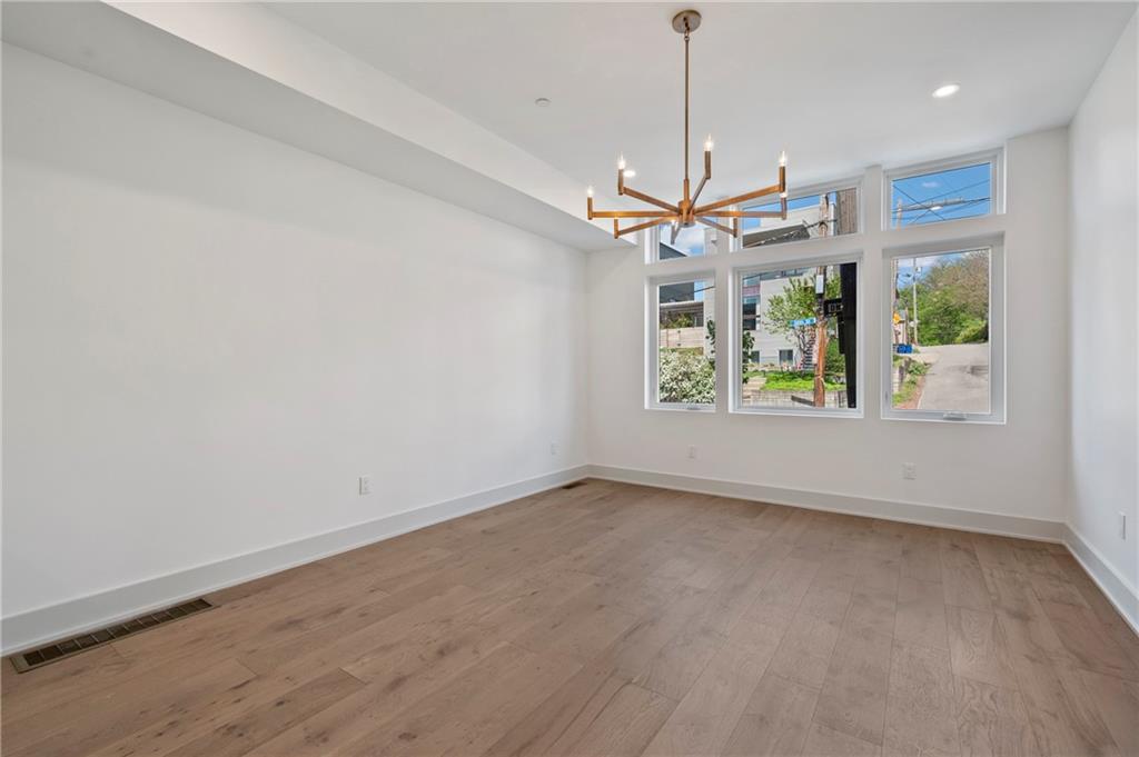 226 38th Street Pittsburgh, PA 15201 - Photo 6 of 42 an empty room with a ceiling fan and window