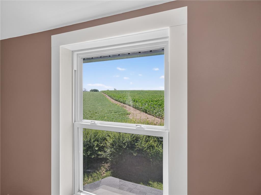 291 East Dannersville Road Bath, PA 18014 - Photo 41 of 46 Framed by a pristine white window, an idyllic rural landscape unfolds under a clear blue sky.