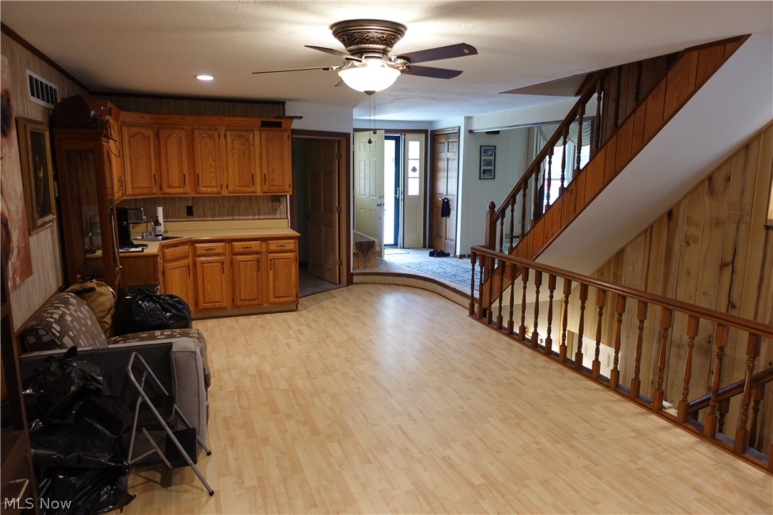 15488 Hatfield Road Rittman, OH 44270 - Photo 7 of 36 Kitchen featuring light hardwood / wood-style floors, ceiling fan, and wooden walls