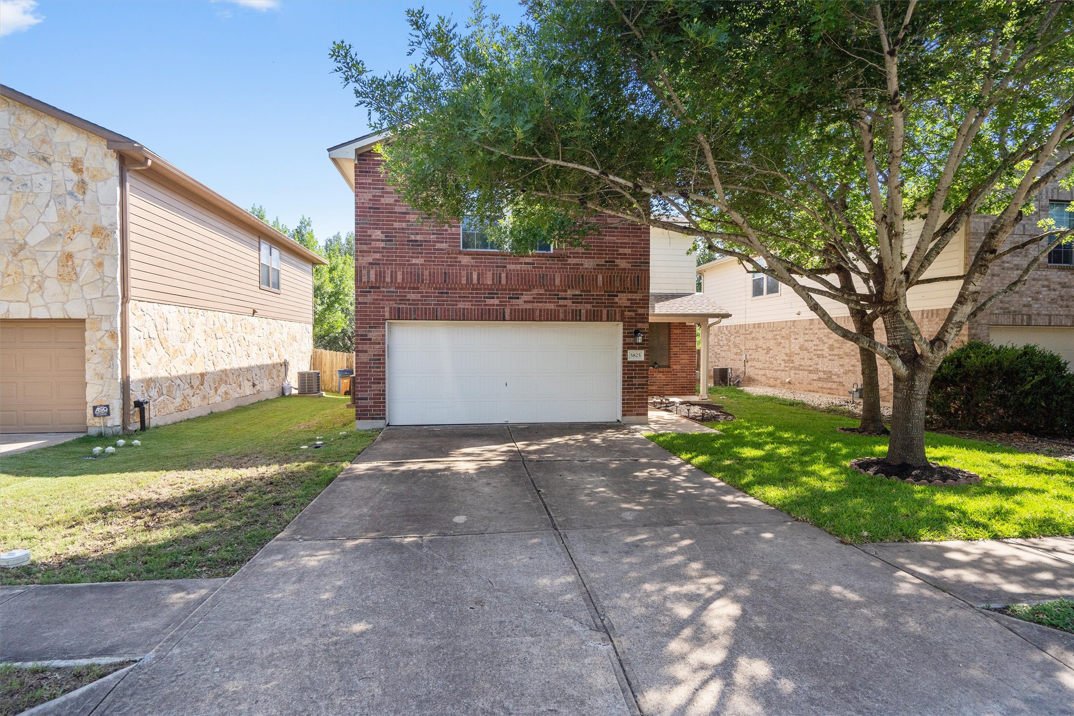 5825 Silver Screen Drive Austin, TX 78747 - Photo 3 of 40 A classic brick facade with a neatly paved driveway provides a welcoming entrance.