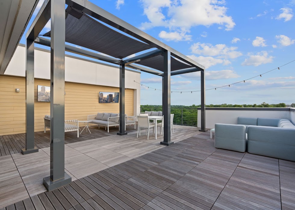 4901 Springdale Road, Unit 2308 Austin, TX 78723 - Photo 3 of 19 An inviting rooftop deck boasts multiple seating areas, offering elevated outdoor living and expansive views.