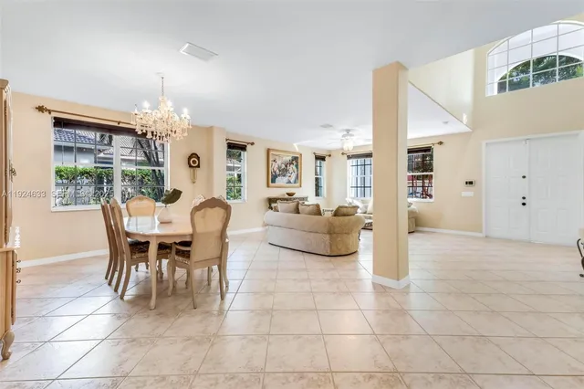 a kitchen with kitchen island granite countertop a sink stove and refrigerator