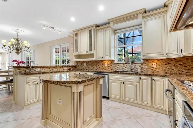 a spacious bedroom with a bed and a chandelier