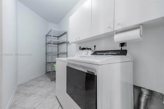 a spacious bedroom with a bed and a chandelier