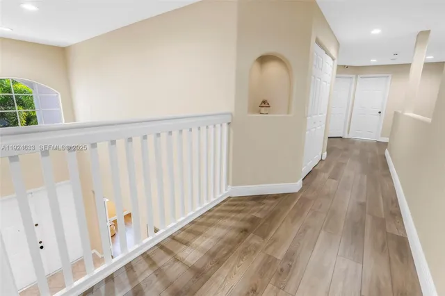 a spacious bathroom with a granite countertop sink a mirror a bathtub and shower