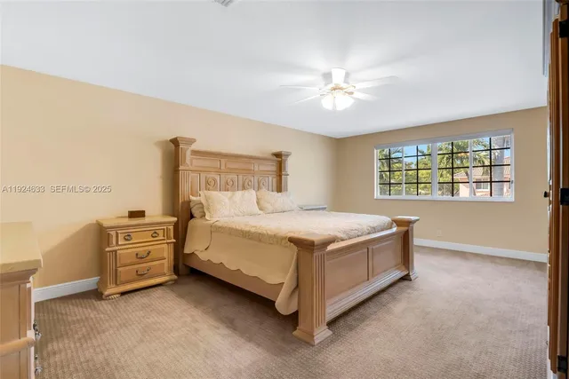 a bathroom with a granite countertop sink vanity mirror next to a shower