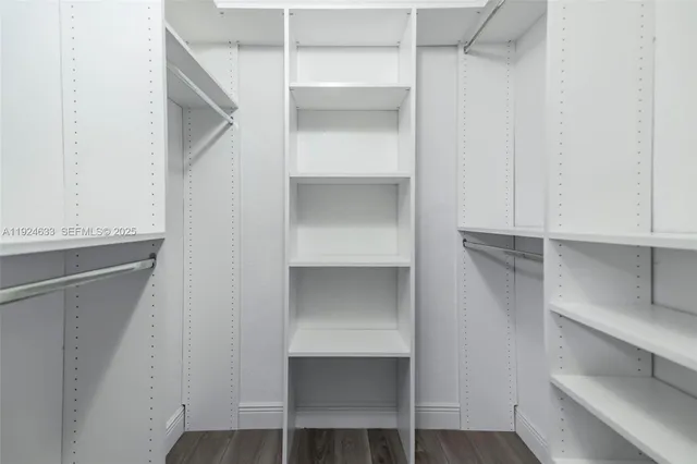 a view of a yard in front of a house with a large tree