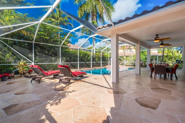 an aerial view of residential houses with outdoor space and swimming pool