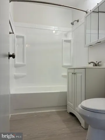 a bathroom with a toilet and a bathtub