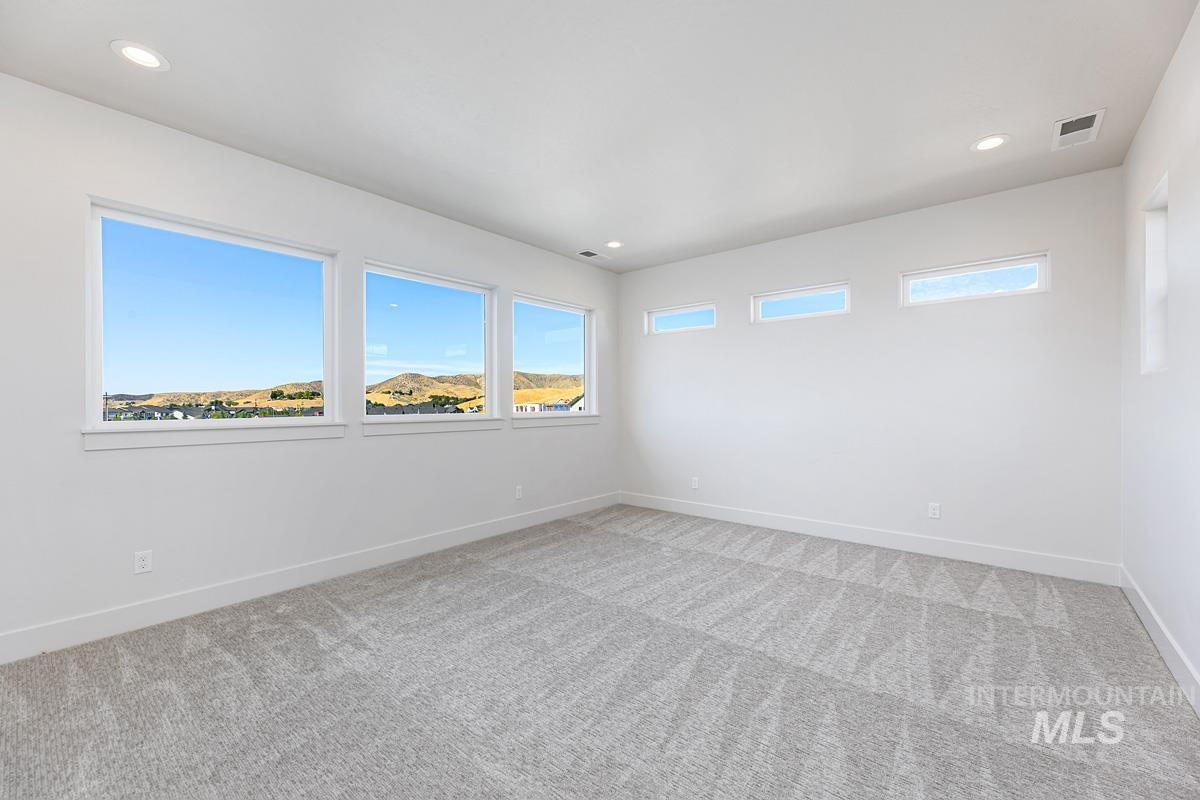 13424 North Spring Creek Way Boise, ID 83714 - Photo 24 of 43 Unfurnished room with recessed lighting and light carpet