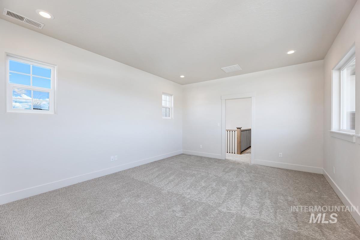 13424 North Spring Creek Way Boise, ID 83714 - Photo 25 of 43 Spare room featuring light carpet and recessed lighting