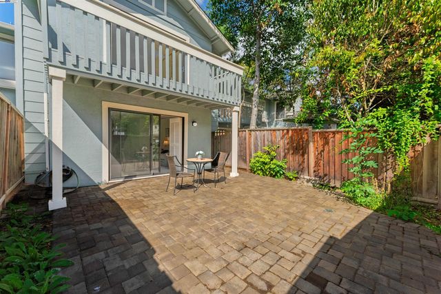 a front view of a house with outdoor seating and wooden floor