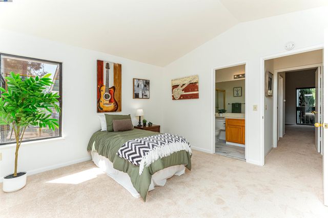 a bedroom with a bed and a potted plant