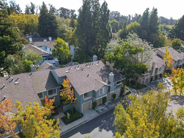 an aerial view of a house with a big yard