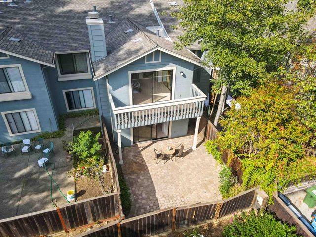 a view of a yard with wooden fence and trees