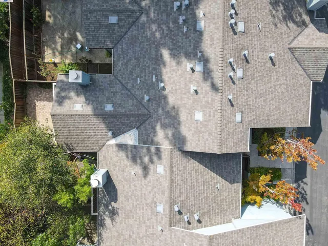 an aerial view of a house with a yard and a fountain