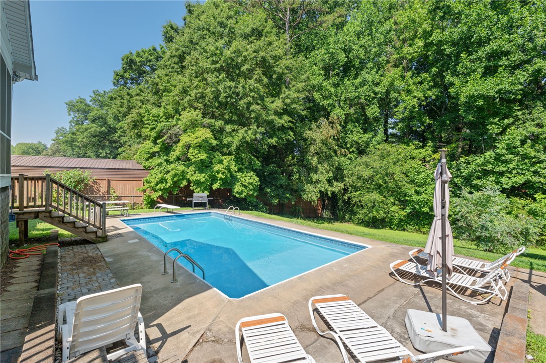 200 Echo Circle Easley, SC 29642 - Photo 29 of 35 An inviting backyard oasis offers a pristine in-ground pool, perfect for leisure.