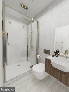 a bathroom with a bathtub shower sink and toilet