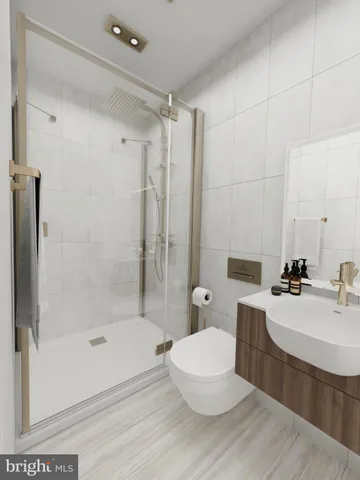a bathroom with a bathtub shower sink and toilet