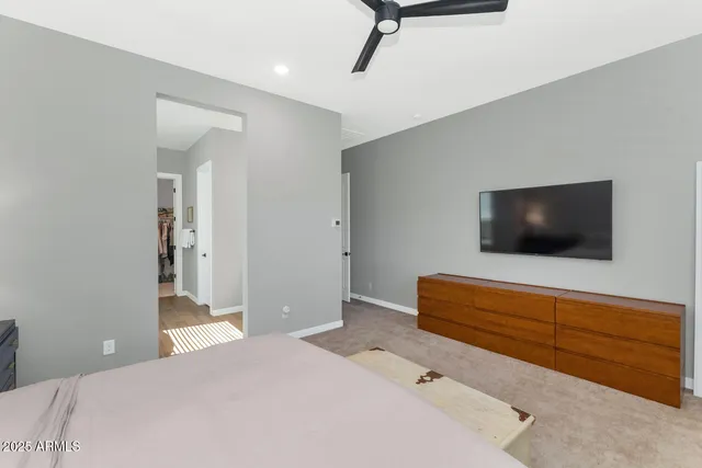 a spacious bedroom with a bed and a table