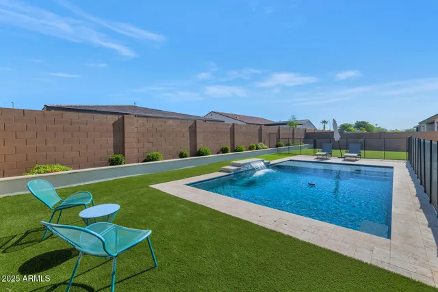 a view of a house with backyard porch and sitting area