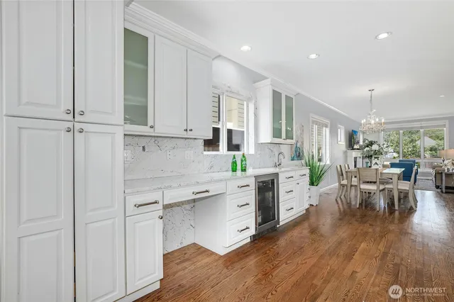 a kitchen with white cabinets and white appliances