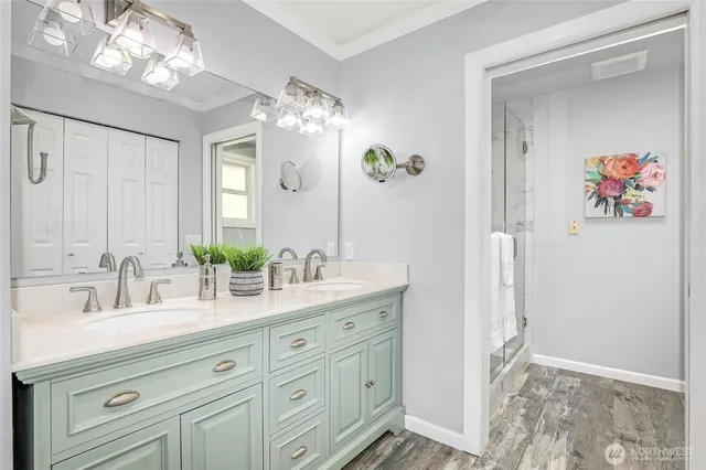 a bathroom with a double vanity sink and a mirror