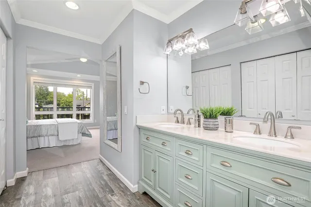 a bathroom with a double vanity sink and a mirror