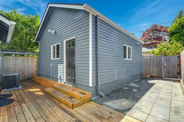 a view of backyard with wooden fence