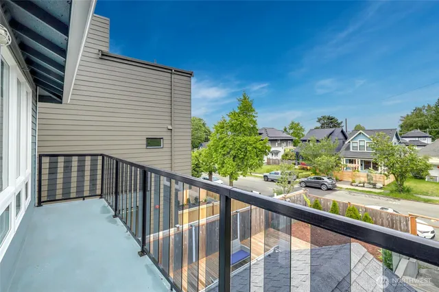 a view of a balcony with flower plants