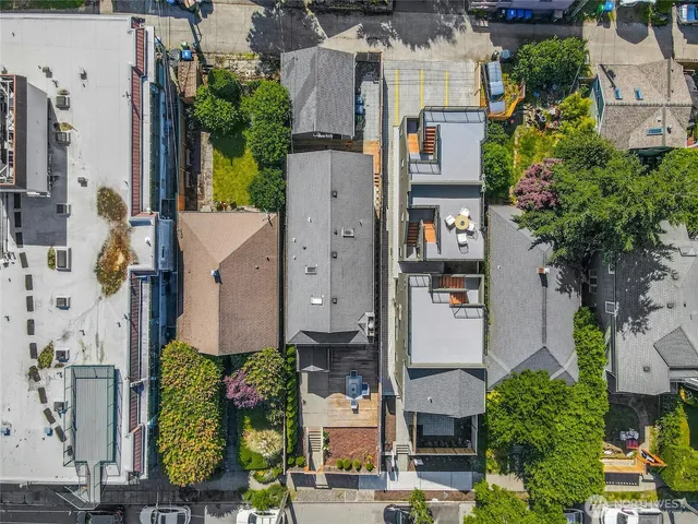 an aerial view of multiple houses with outdoor space