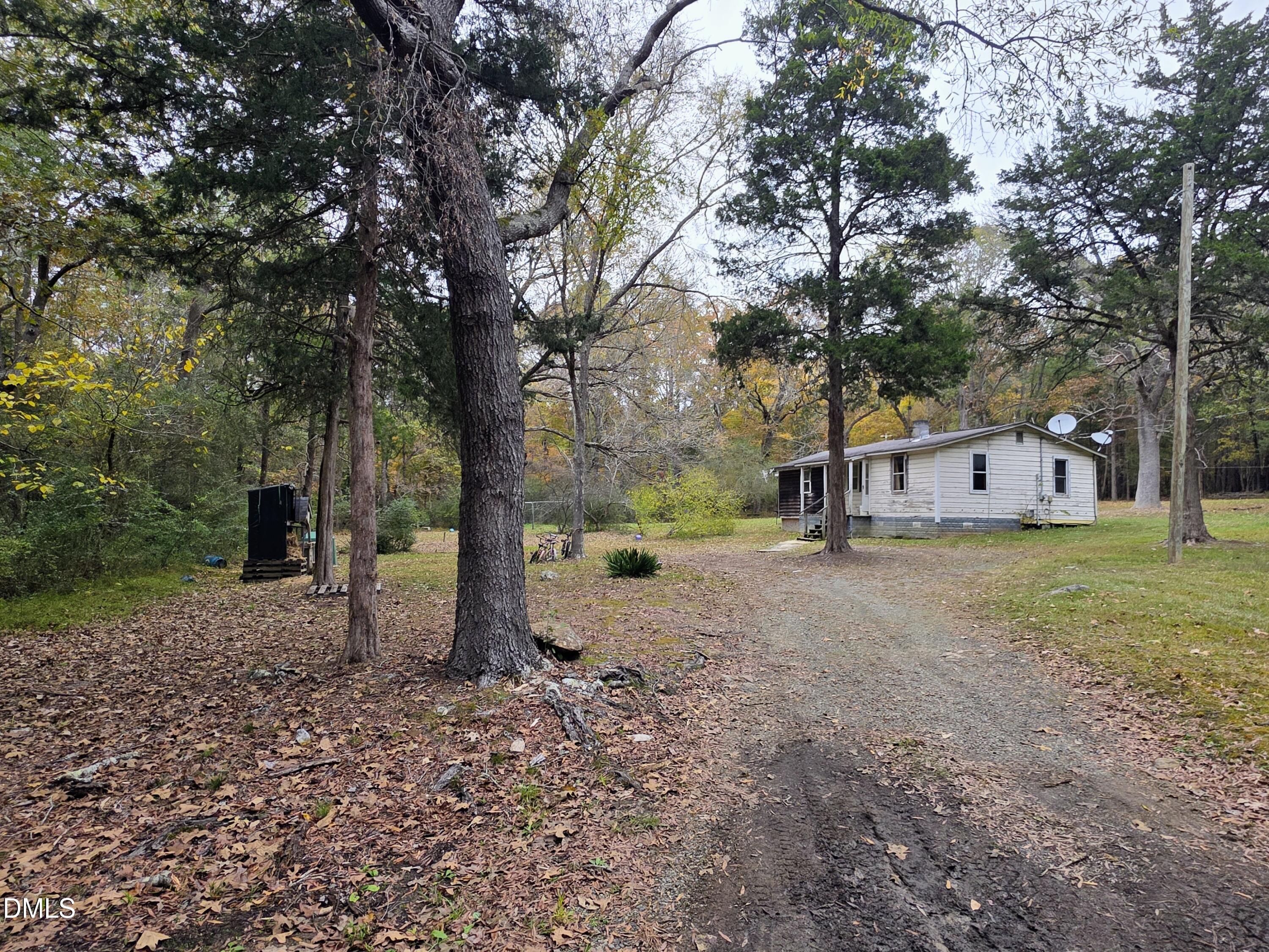 a view of a house with a yard and tree s