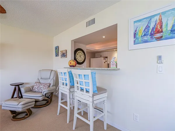 a living room with furniture and a clock