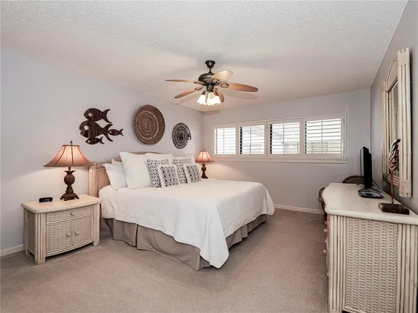 a bedroom with bed and a chandelier