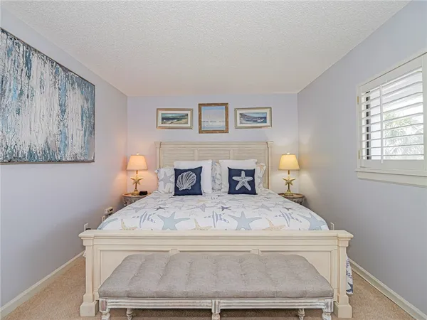 a bedroom with a bed and a lamp on table