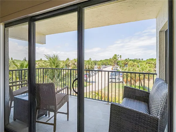a view of a city from a balcony with furniture