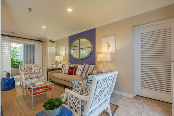 a living room with furniture a rug and a window