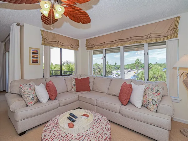 a living room with furniture and a large window