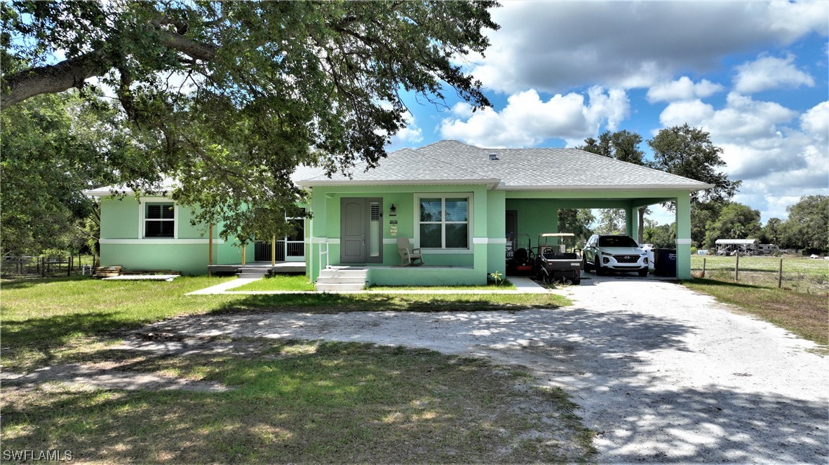 23170 North River Road Alva, FL 33920 - Photo 1 of 50 a view of a house with backyard porch and sitting area